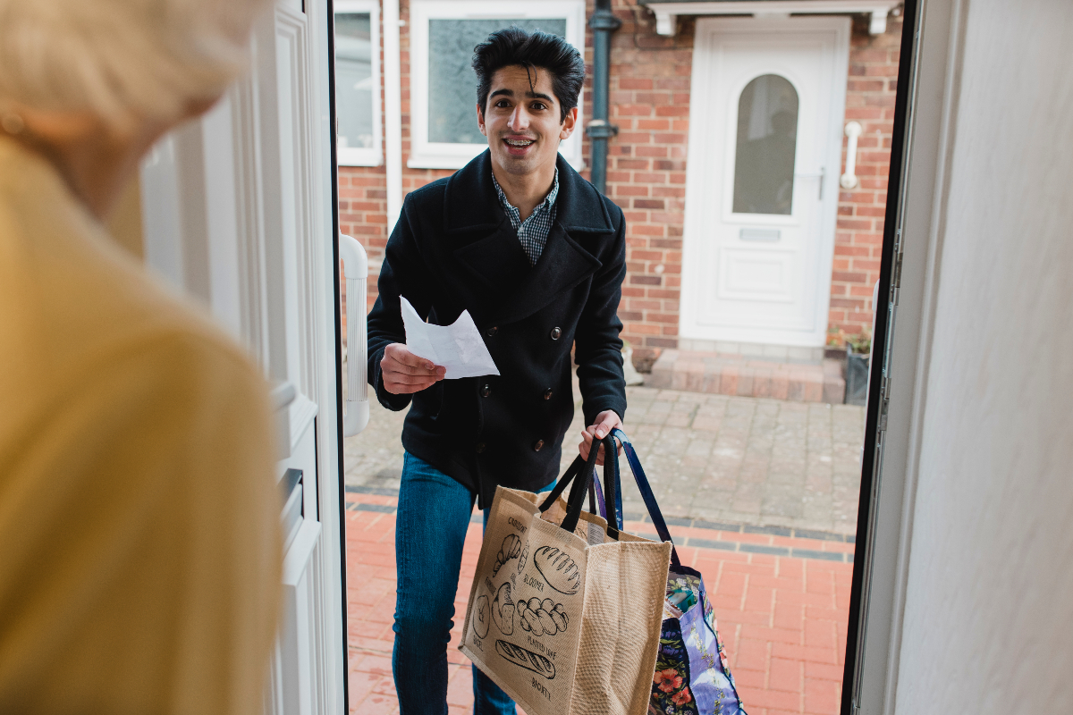 NHS Volunteer delivers food shopping to a home