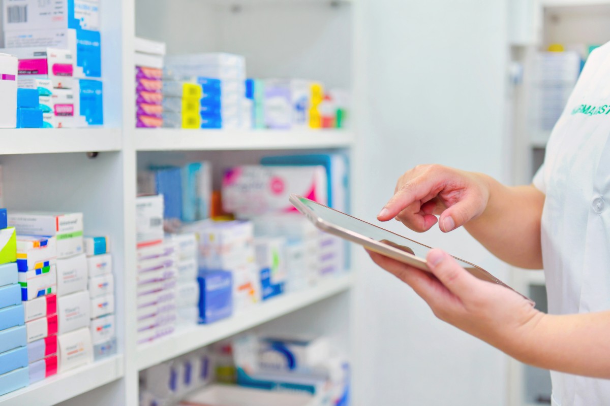 Pharmacist holding computer tablet