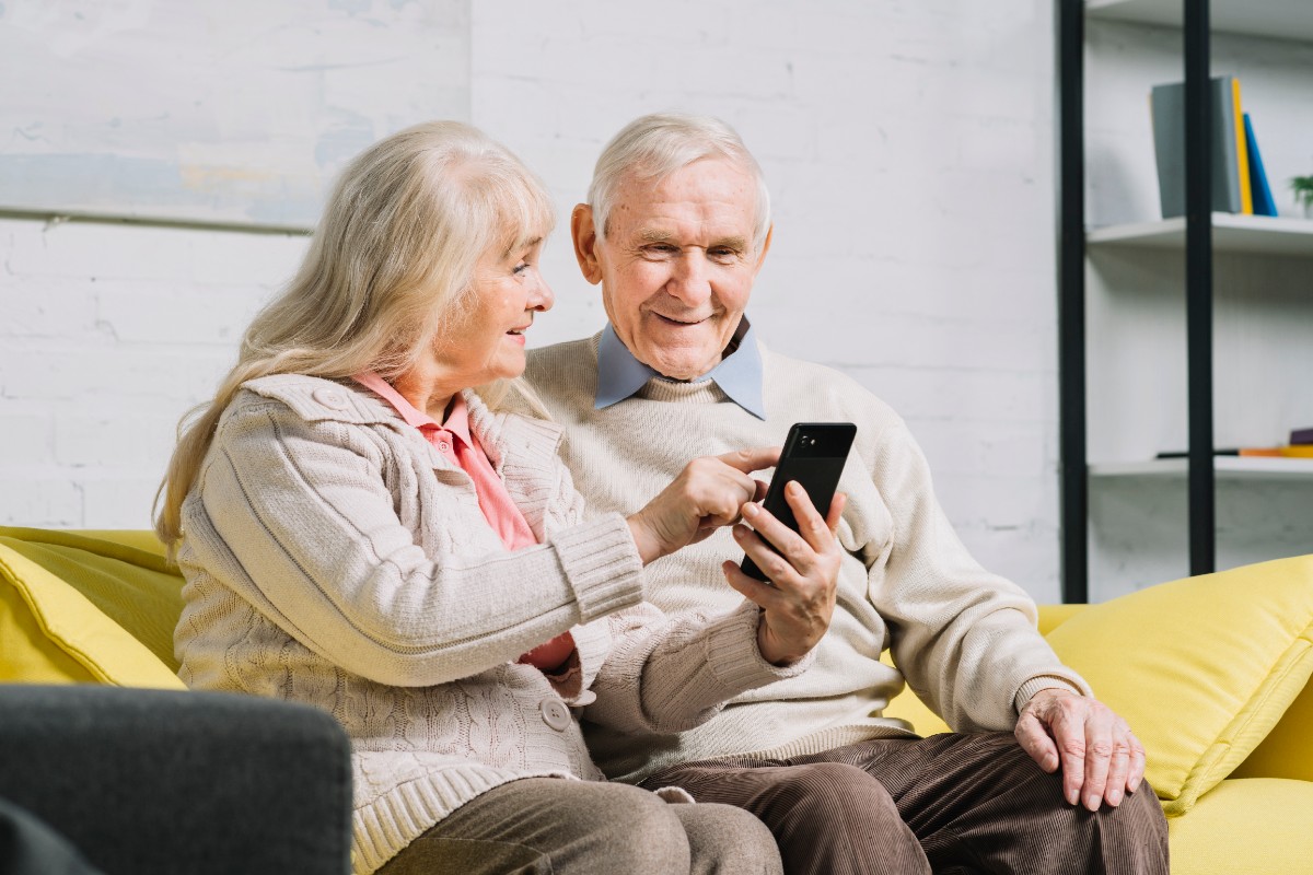 Elderly couple using app on mobile phone