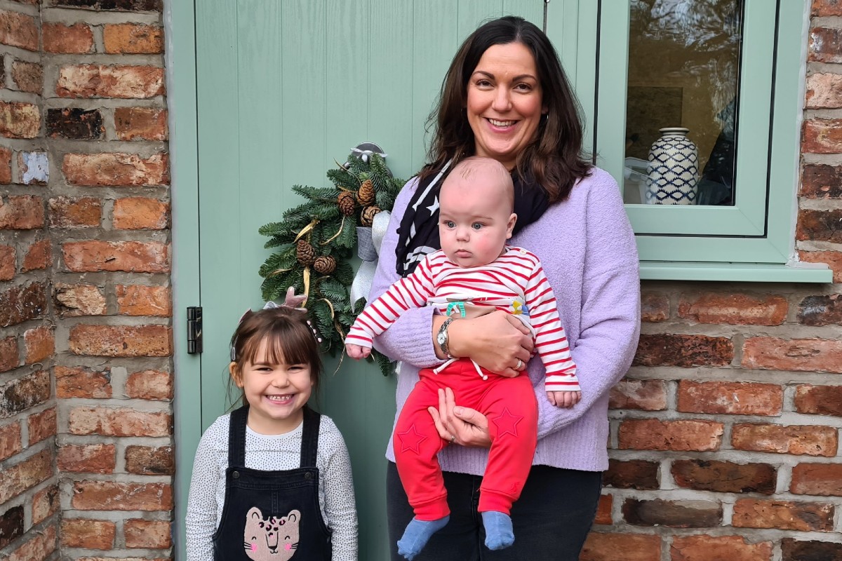 Rose McGarty holding baby Arlo with Ruby, aged 5, stood next to her