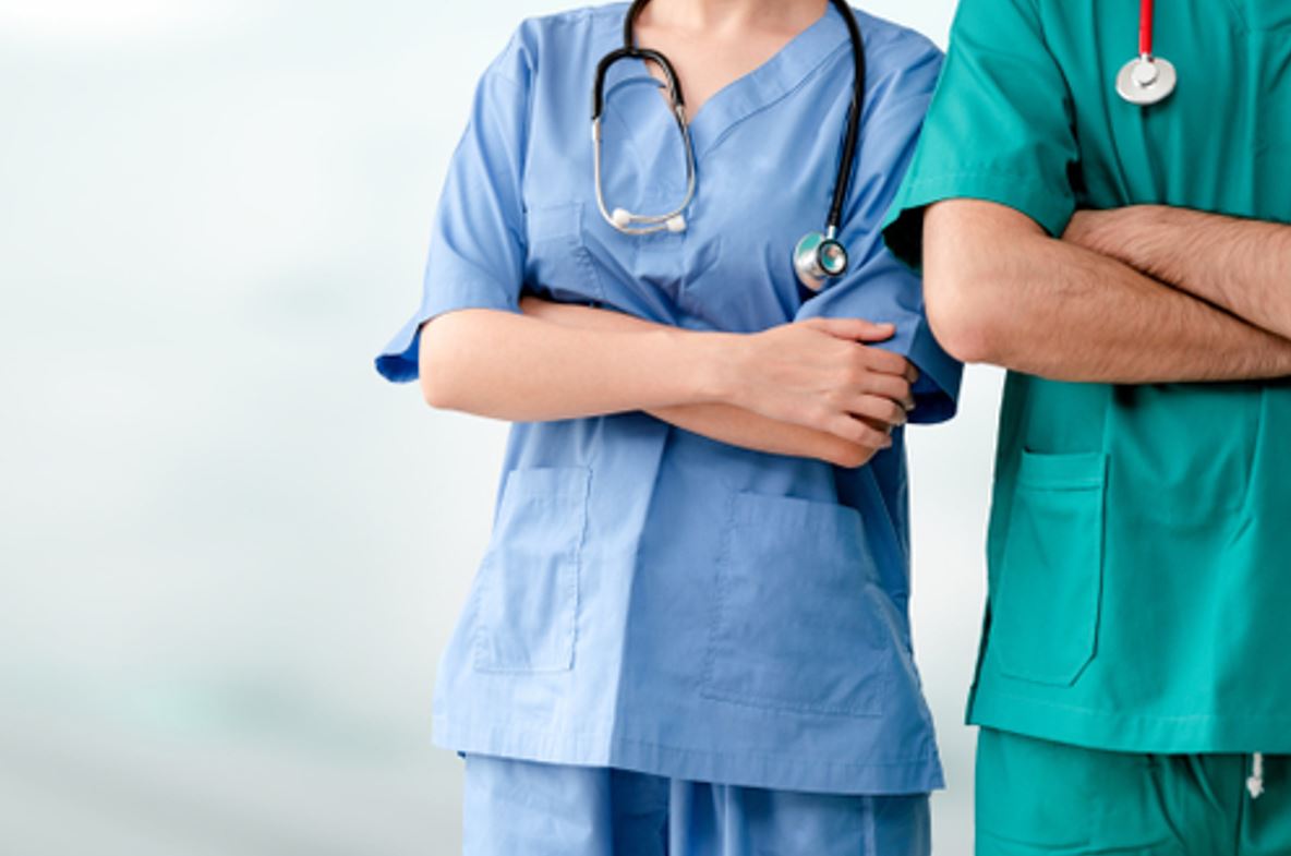 Nurses in green and blue uniforms
