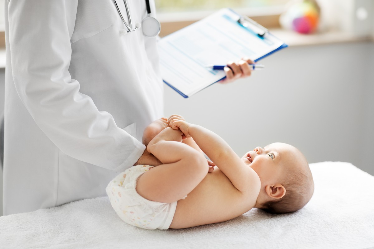 medicine, healthcare and pediatrics concept - female pediatrician or neuropathist doctor or nurse checking baby patient's at clinic or hospital