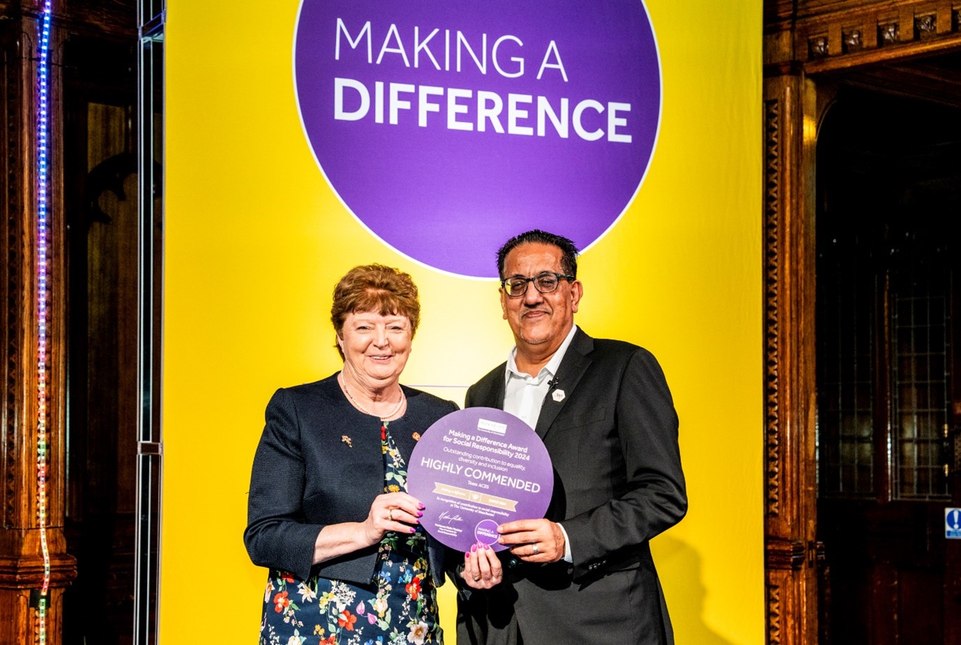 Kathy Cowell, MFT Chairman accepted the award on behalf of Team ACES, pictured with Nazir Afzal OBE, University of Manchester Chancellor.