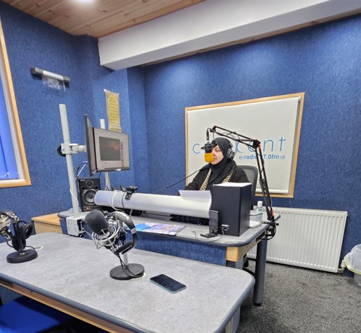 Sanya presenting on the local radio station Crescent Community Radio