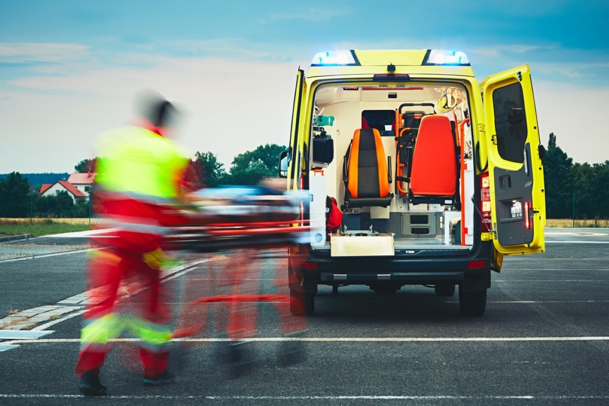 Patient being wheeled towards an ambulance