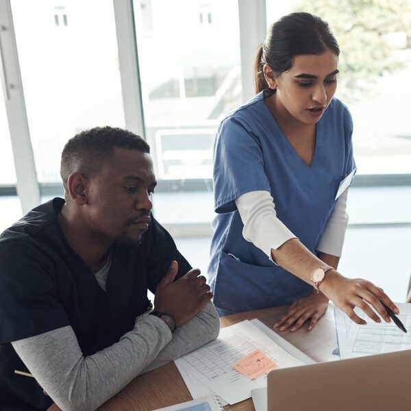 students collaborating around a laptop